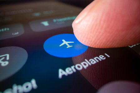 Close-up view of switching smartphone to airplane mode, shot with macro probe lensの写真素材