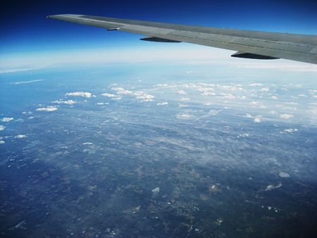 Airplane wing, aerial as plane approaches New York City