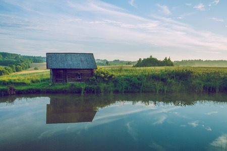 Sunrise at the pond with a view of the room and meadow. 2016の写真素材