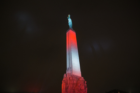 Riga, Latvia, Staro Riga festival. Freedom monument in Riga at night.の写真素材