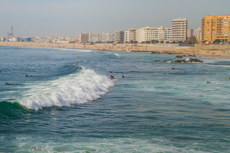 City Porto, Portugal. Ocean, surfers and blue water. People surfing.のeditorial素材