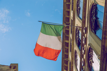 Italy flag at street, Europe. Street, buildings and sky.の写真素材