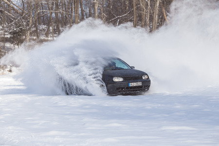City Cesis, Latvia, Frozzen lake and Volkswagen golf. Ice and cold, power and speed. Travel photo 2018.のeditorial素材