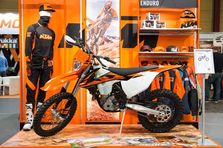 City Riga, Latvia. Car and motorcycle exibition. Motorcycle KTM, peoples and advertising. 25.03.2018 Travel photo.のeditorial素材