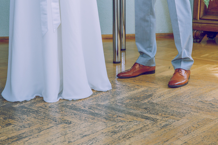 City Riga, Latvia. Brown shoes and white weddings dress. Travel photo 2018.の写真素材