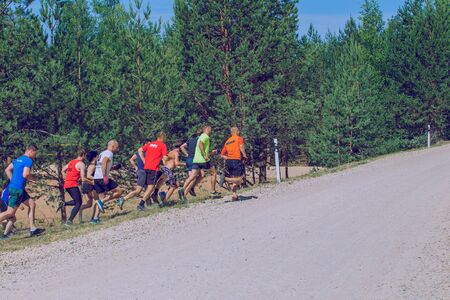 City Ikskile, Latvia. Daring race, sport event. Outdoor training, people are running. Sunny day....