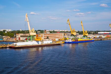 City Riga, Latvia. Cargo port, ships and river Daugava. Big ships, old buildings. Travel photo.
