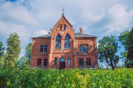City Cirsta, Latvia. Old manor house and meadow, green trees. Travel photo 2018.のeditorial素材