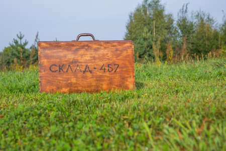 City Kraslava, Latvia. Old woden retro suitcase and nature.