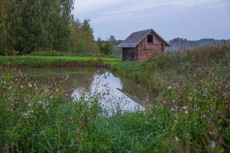 City Kraslava, Latvia. Bath house at early morning, green grass and lights. Water and nature.の写真素材