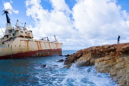 City Paphos, Cyprus. Old ship wreck  and girl. Blue water beach. Travel photo 2018, december. Landscape and nature.のeditorial素材