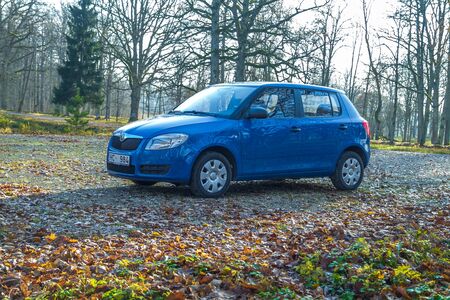 City Cesis, Latvia. Blu Skoda Fabia to street, trees an way. Autumn, travel photo 2012.