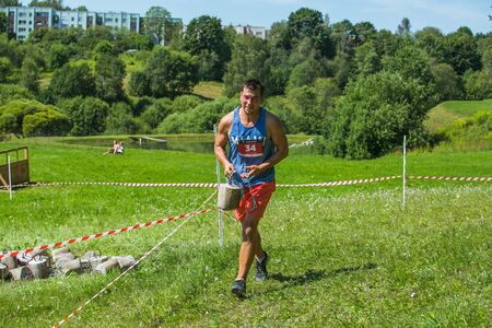 City Cesis, Latvian Republic. Run race, people were engaged in sports activities. Overcoming various obstacles and running.  July 21. 2019.のeditorial素材