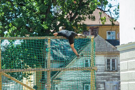 City Cesis, Latvian Republic. Run race, people were engaged in sports activities. Overcoming various obstacles and running.  July 21. 2019.のeditorial素材
