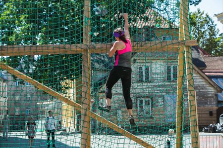 City Cesis, Latvian Republic. Run race, people were engaged in sports activities. Overcoming various obstacles and running.  July 21. 2019.のeditorial素材