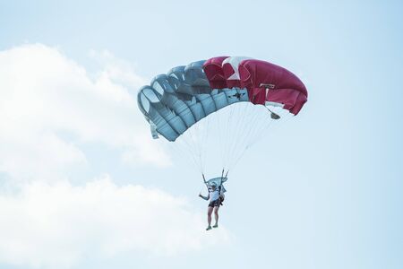 City Riga, Latvian republic. Avio show in honor of the city festival. Parachutists land with parachutes on target. 17 August 2019.のeditorial素材