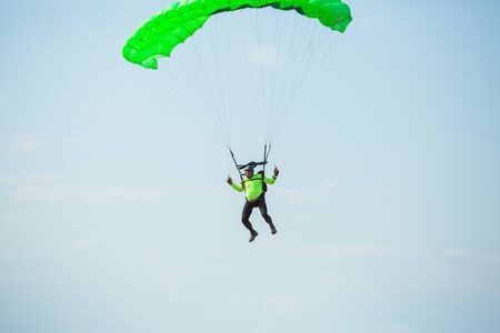 City Riga, Latvian republic. Avio show in honor of the city festival. Parachutists land with...