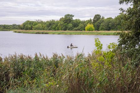 City Carnikava, Latvian Republic. Fisherman catching fish in the river, nature, silence and water waves. Sep 04. 2019.のeditorial素材