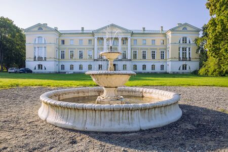 City Mezotne, Latvia Republic. Park with old castle. Fountain and green zone. Sep 9. 2019 Travel photo.のeditorial素材