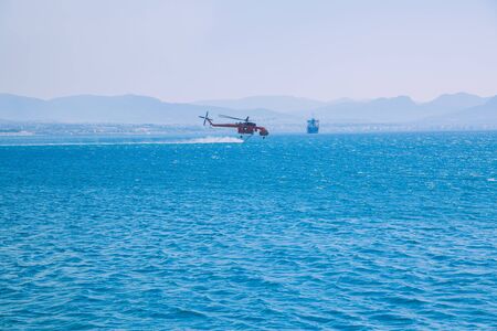 Moni Osiou Patapiou, Greek Republic. The helicopter fills with water to extinguish the fire. 14. Sep. 2019のeditorial素材