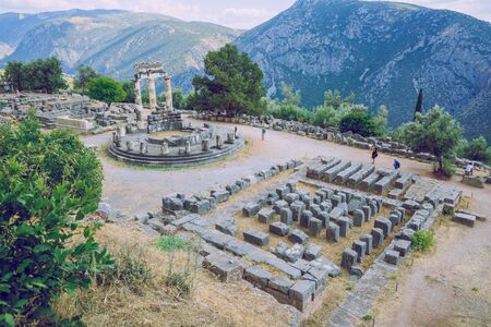 City Delphi. Greek Republic. Ancient Greek ruins and columns from ancient times.  Walking tourists....