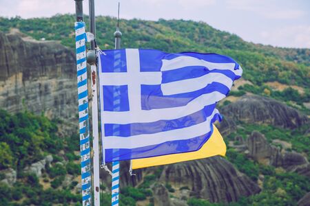City Meteora, Greek Republic. Mountains and Greek flag. 12. Sep. 2019. Travel photo.