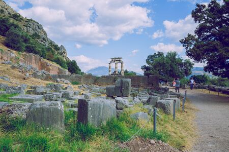 City Delphi. Greek Republic. Ancient Greek ruins and columns from ancient times.  Walking tourists....
