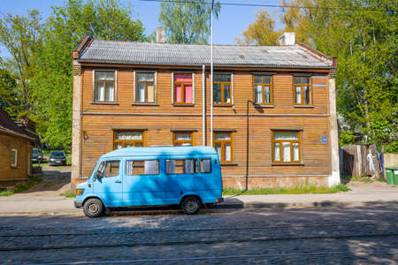 City Riga, Latvia.On the street old passenger mini bus and wooden building.29.05.2020のeditorial素材
