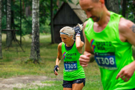 City Riga, Latvia. Run race, people were engaged in sports activities. Overcoming various obstacles and running.  5.07.2020のeditorial素材