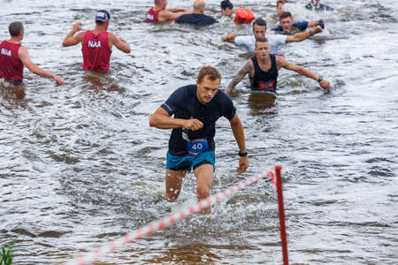 City Plavinas, Latvia. Run race, people were engaged in sports activities. Overcoming various obstacles and running.18.07.2020のeditorial素材