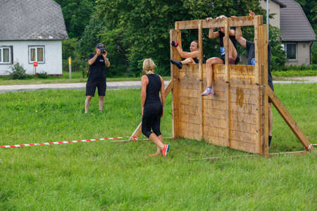 City Plavinas, Latvia. Run race, people were engaged in sports activities. Overcoming various obstacles and running.18.07.2020のeditorial素材