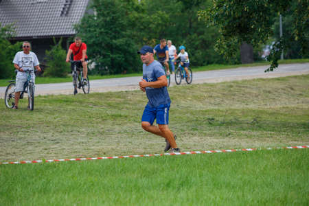 City Plavinas, Latvia. Run race, people were engaged in sports activities. Overcoming various obstacles and running.18.07.2020のeditorial素材