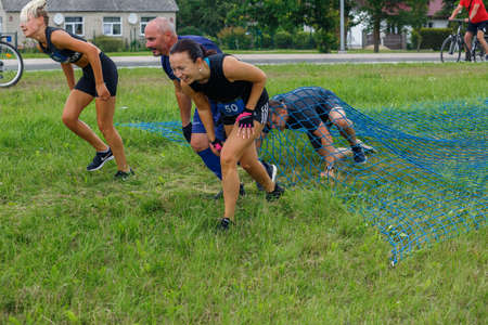 City Plavinas, Latvia. Run race, people were engaged in sports activities. Overcoming various obstacles and running.18.07.2020のeditorial素材