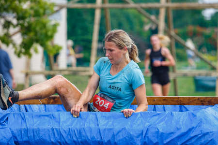 City Plavinas, Latvia. Run race, people were engaged in sports activities. Overcoming various obstacles and running.18.07.2020のeditorial素材