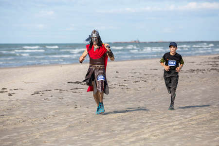 City Liepaja,Latvia.A Viking with a weapon in his hands runs along the sea shore.19.09.2020のeditorial素材