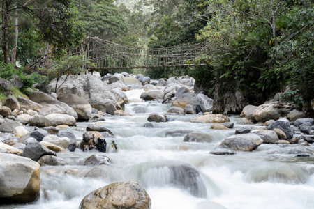 Mountain river with a wooden bridge in the background, Thailand.の写真素材
