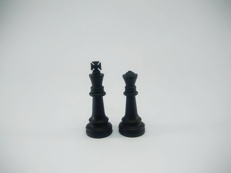 Black plastic couple of king and queen chess piece isolated on a white backgroundの写真素材