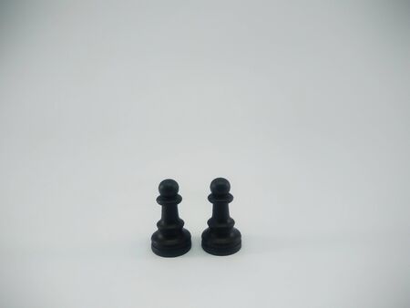 Black plastic pair of pawn chess piece isolated on a white backgroundの写真素材