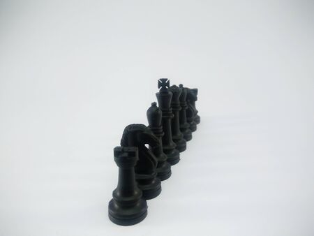 Black plastic king queen bishop knight rook line up chess piece isolated on a white backgroundの写真素材