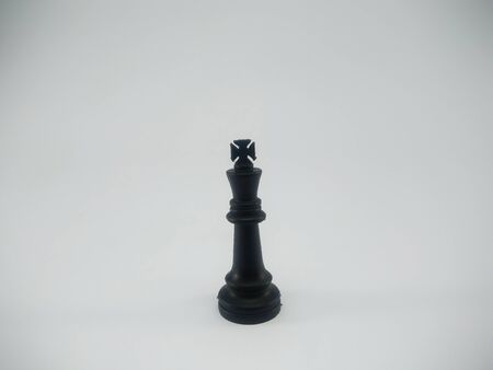 Black plastic king chess piece isolated on a white backgroundの写真素材