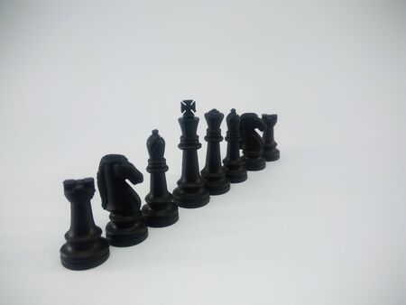 Black plastic king queen bishop knight rook line up chess piece isolated on a white backgroundの写真素材