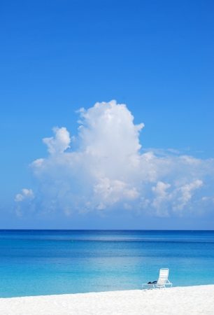 The turquoise sea stretches to the horizon with towering couldsの写真素材