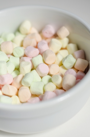 Multi-colored marshmallow in a white bowlの写真素材