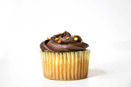 Chocolate cupcake with colorful sprinklesの写真素材