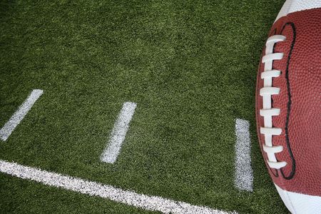 A photo of an American Football field yardage markings with a football on the right border