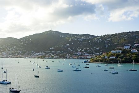 The harbor of a beautiful tropical island filled with sailboats as the sun begins to set on a gorgeous day in St. Thomas Virgin Islandsの写真素材