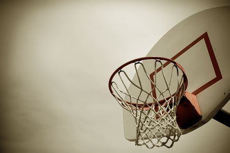 A horizontal cross processed basketball hoop background. Lots of Copy space room and cool sepia filter feel.の写真素材
