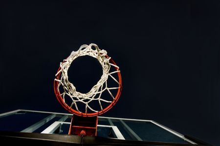 Basketball basket and net shot from below. A unique view in a basketball arena with only the basket lit. Lots of Copy space roomの写真素材