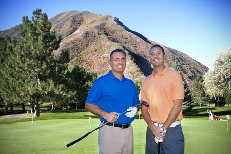 Two male golfers playing golf togetherの写真素材