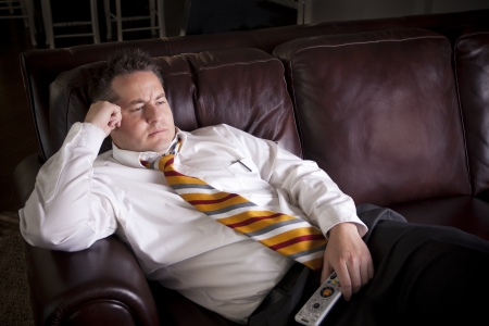 Lazy Male watching Television at homeの写真素材